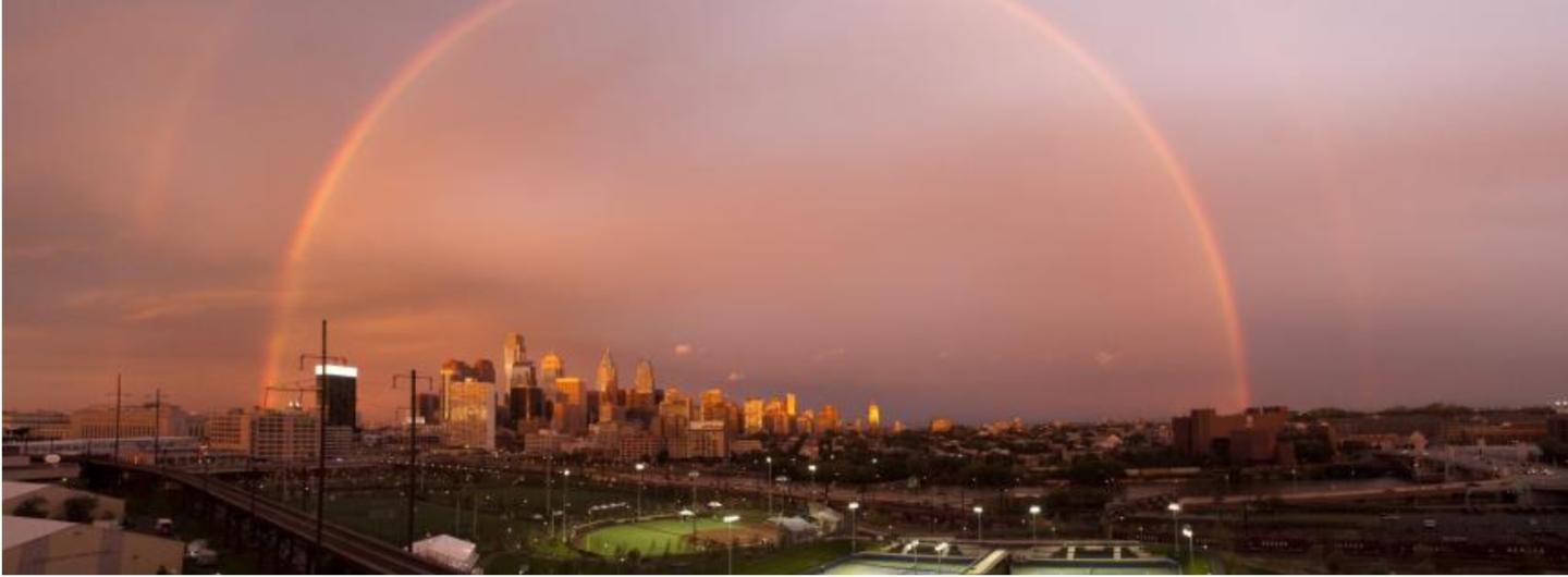 A rainbow over a city like a shield 