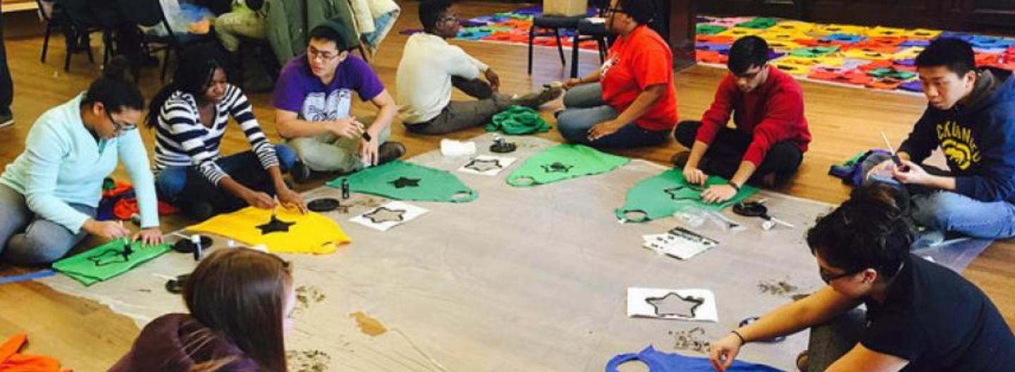 A group of students working on projects reflecting learning and awarness